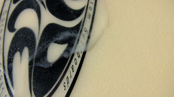Surf wax over board logo